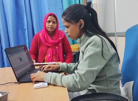Nisha (MTE) taking patient history at Polyclinic, Sec. 31, Gurgaon