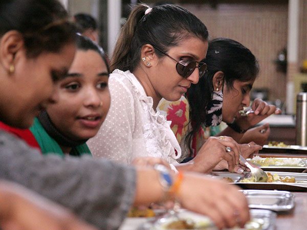 blind women heaving meal together