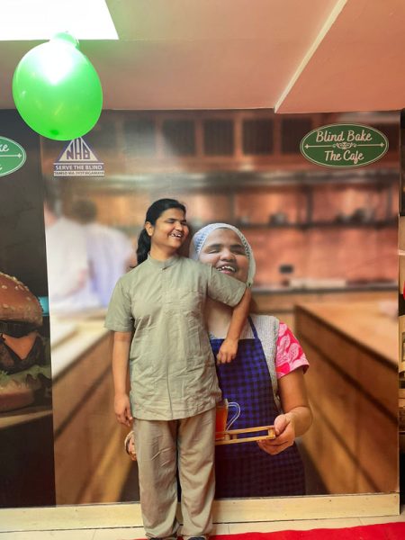 Image of a blind Womenchef with her poster